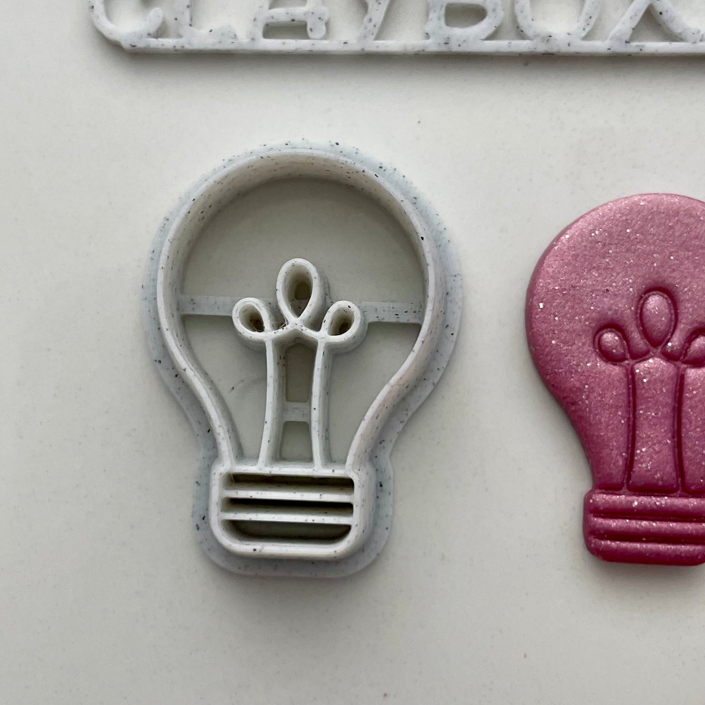 Lightbulb combined stamp/cutter