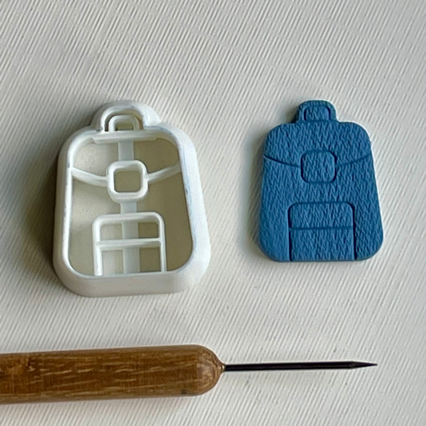 Backpack combined stamp/cutter