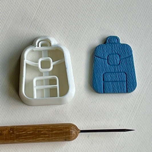 Backpack combined stamp/cutter